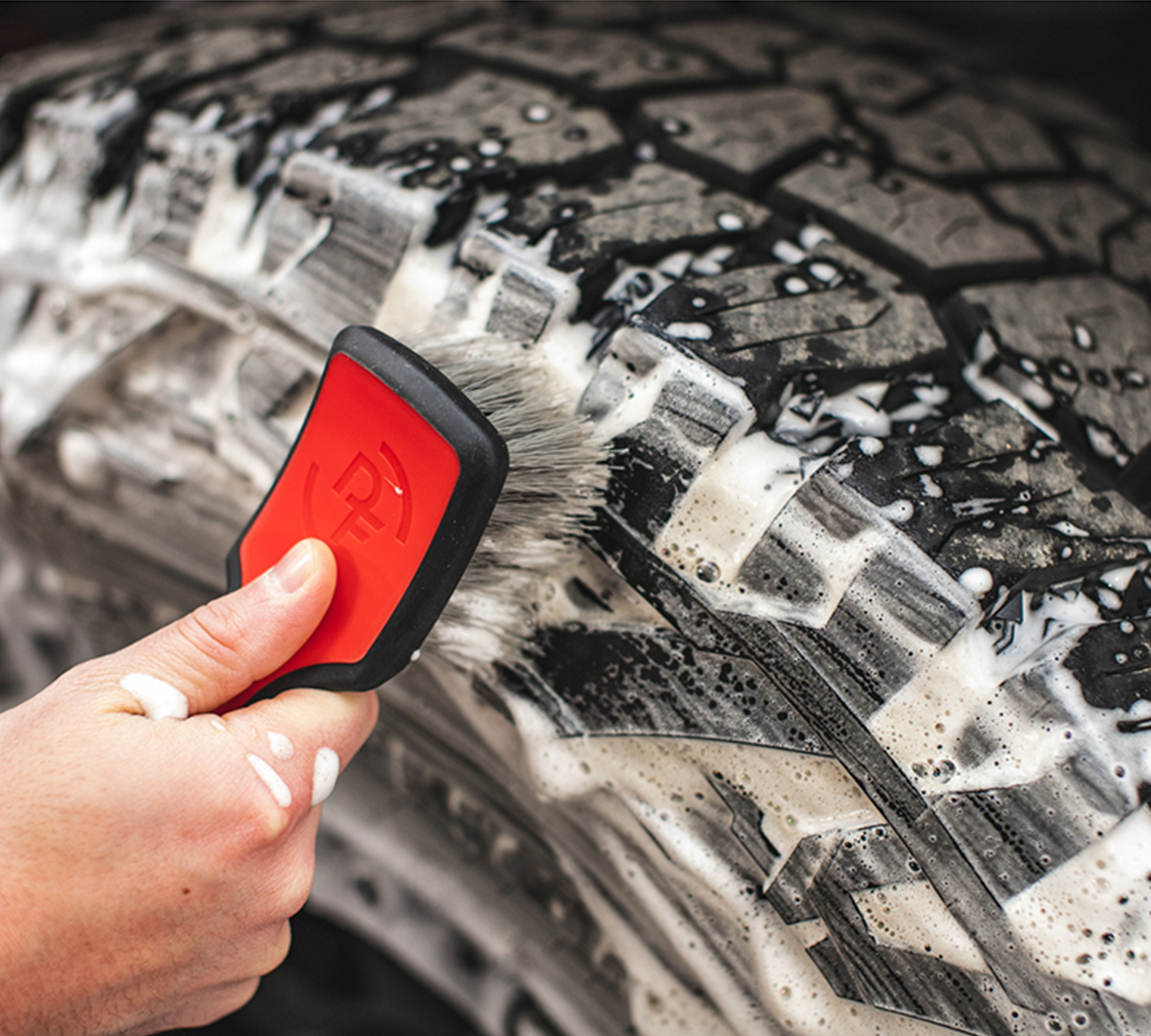 
                  
                    Tire Scrub Brush being used to clean car tire
                  
                