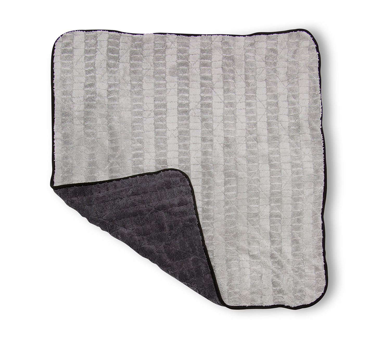 The Gauntlet XL Premium Drying Towel – 30in X 36in laid out with one corner pulled up