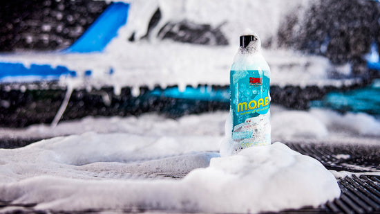 Moab foaming car wash bottle on a soapy blurred background