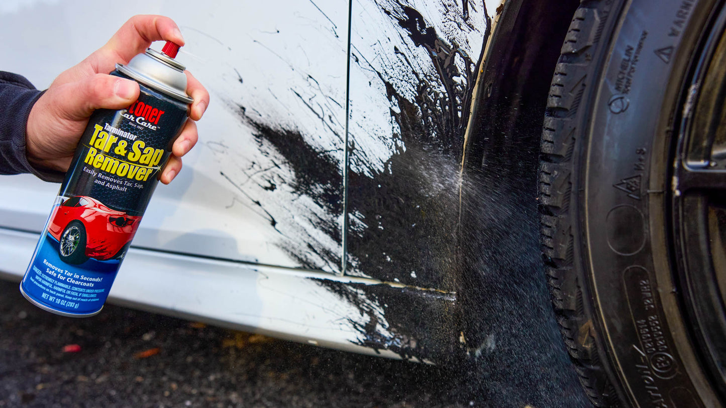 Person using a can of Tarminator on a car.